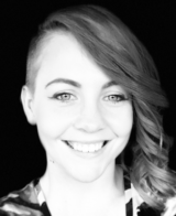 Black and white portrait of a smiling woman with short wavy hair created using Biteable video maker.